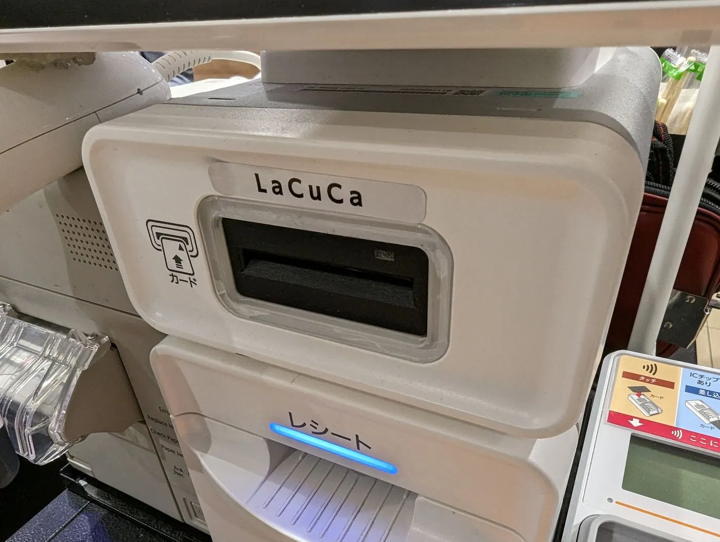 A card payment terminal reading a customer's card at checkout
