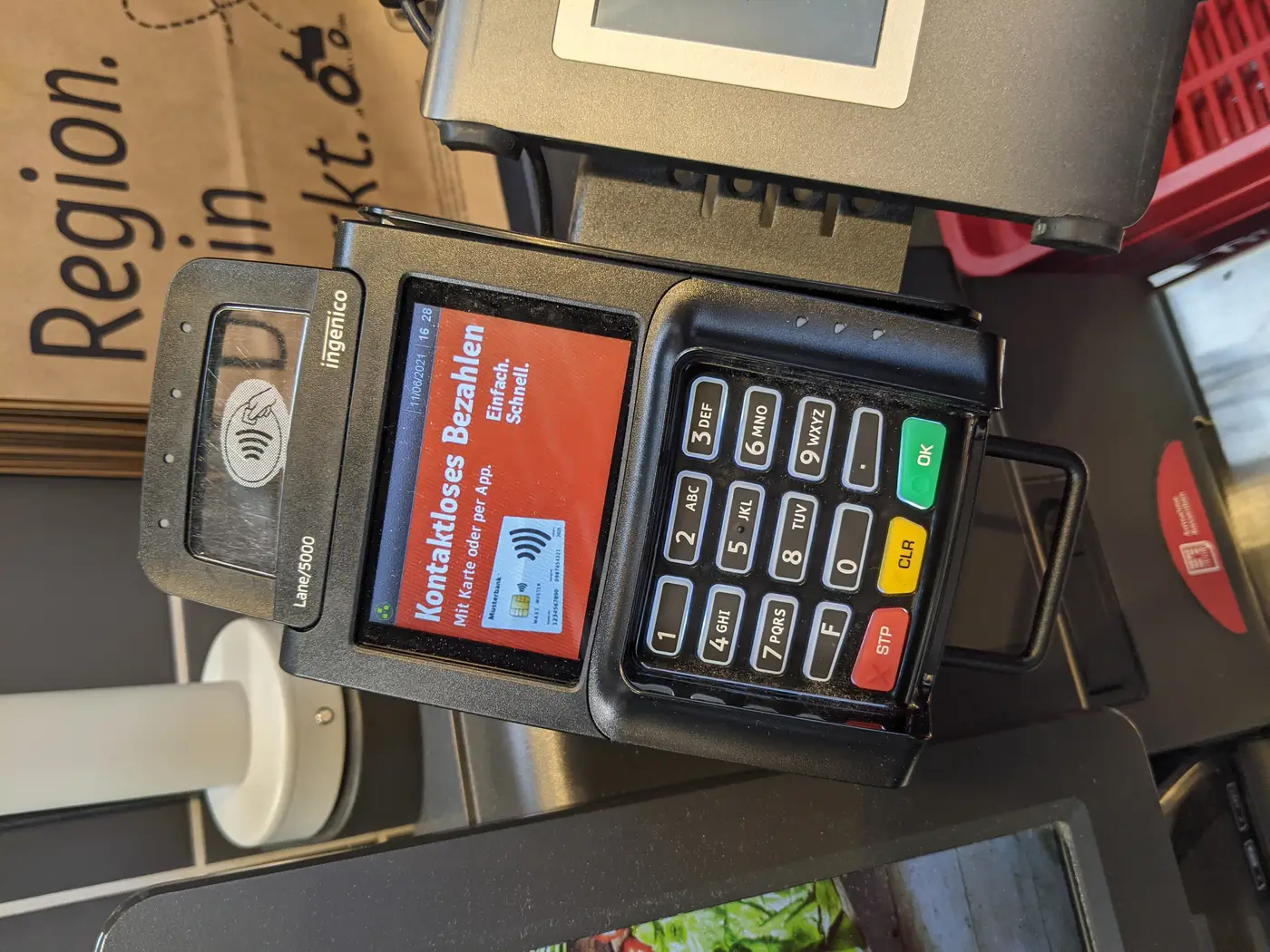 A contactless payment terminal at a self-checkout station