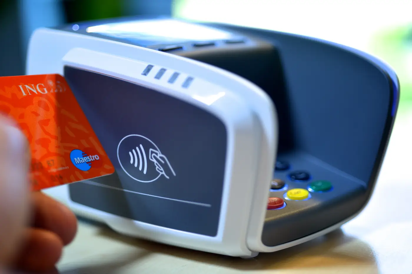 A European bank debit card next to a contactless payment symbol